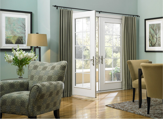 Decorative drapery hardware room scene with UDesign black free traverse rod above a sliding glass door